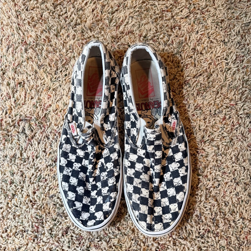 Vans limited edition Peanuts black/white Checkered Slip-Ons that are Snoopy.